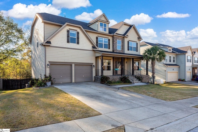 view of front of home with a porch, a garage, and a front yard