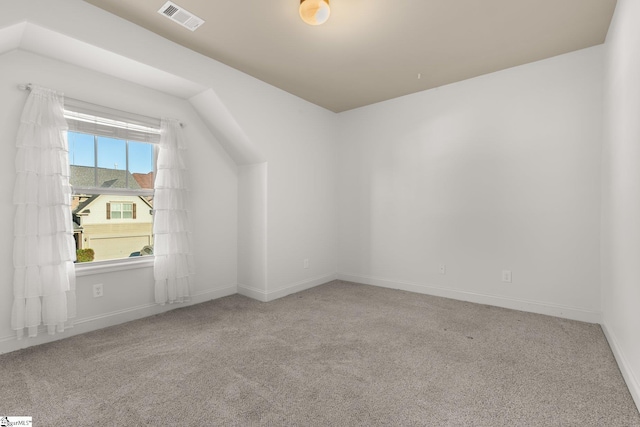 bonus room with light carpet and lofted ceiling