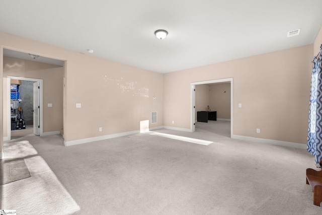 unfurnished room with light carpet