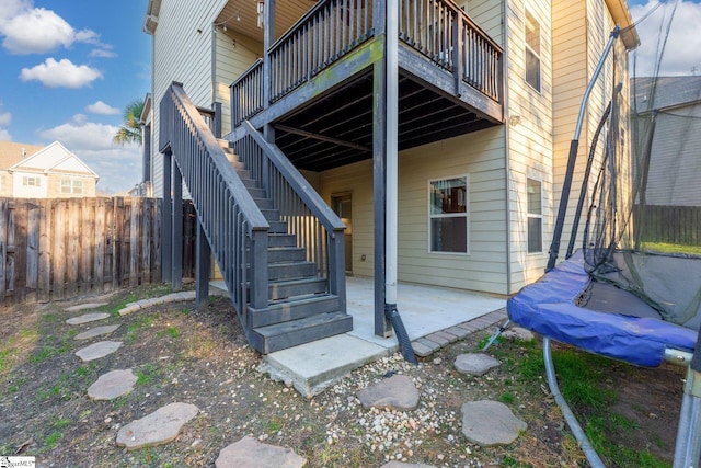 property entrance featuring a patio and a balcony