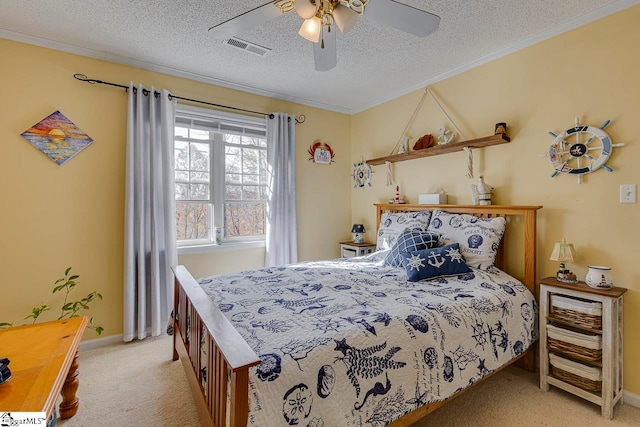 bedroom featuring ceiling fan, crown molding, light carpet, and a textured ceiling