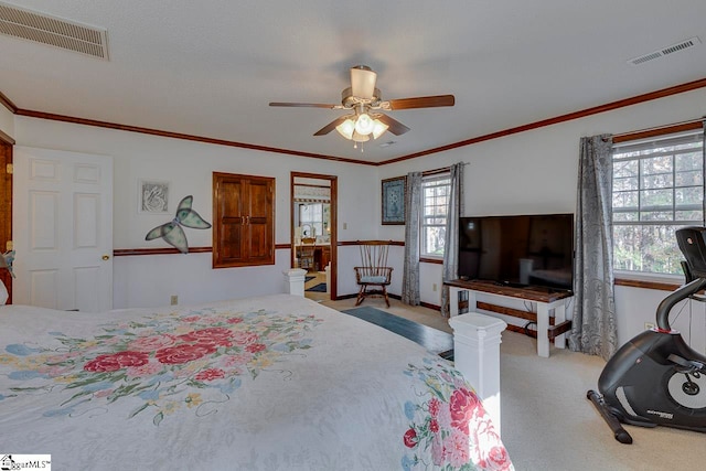 carpeted bedroom featuring ceiling fan and ornamental molding