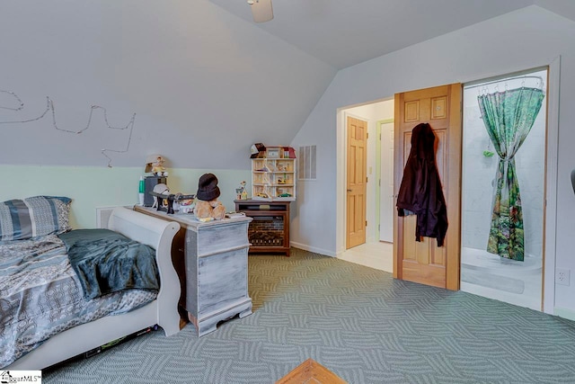 bedroom with light colored carpet and lofted ceiling