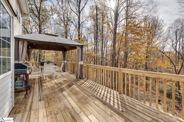 wooden terrace featuring a gazebo and area for grilling