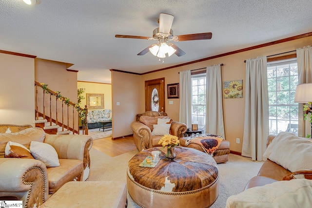 carpeted living room featuring ceiling fan, a textured ceiling, and ornamental molding