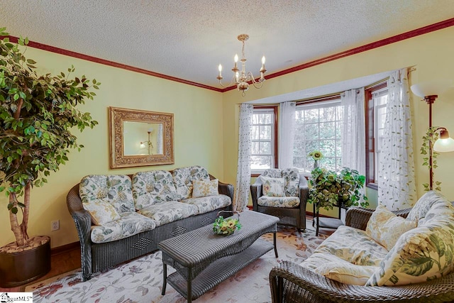 living room featuring ornamental molding, a textured ceiling, and an inviting chandelier