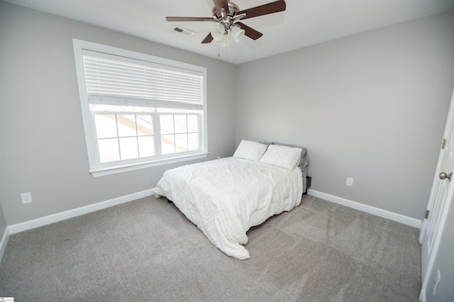 bedroom featuring light carpet and ceiling fan