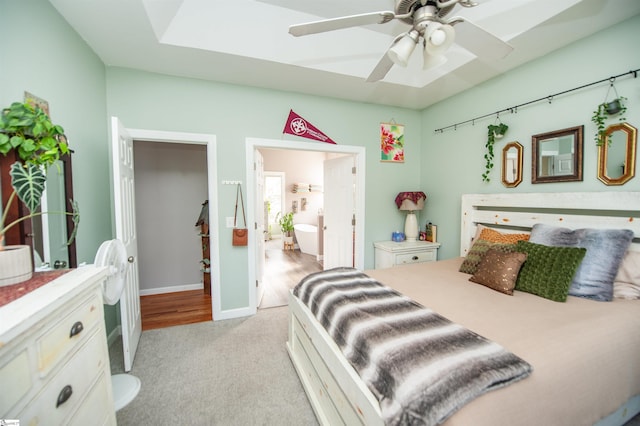 carpeted bedroom featuring ceiling fan and connected bathroom