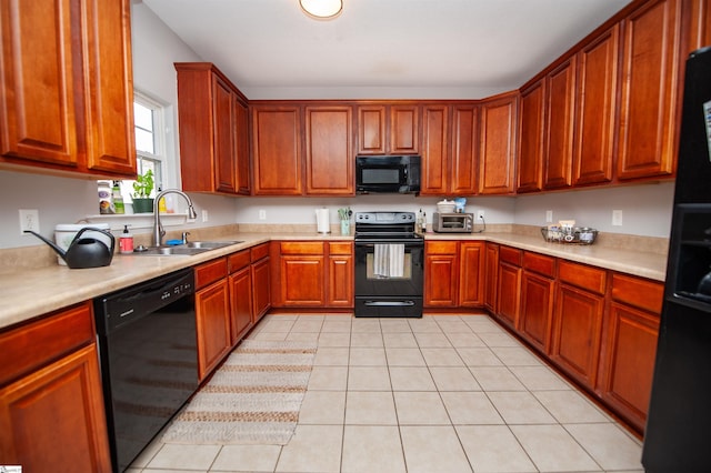 kitchen with black appliances, light tile patterned floors, and sink