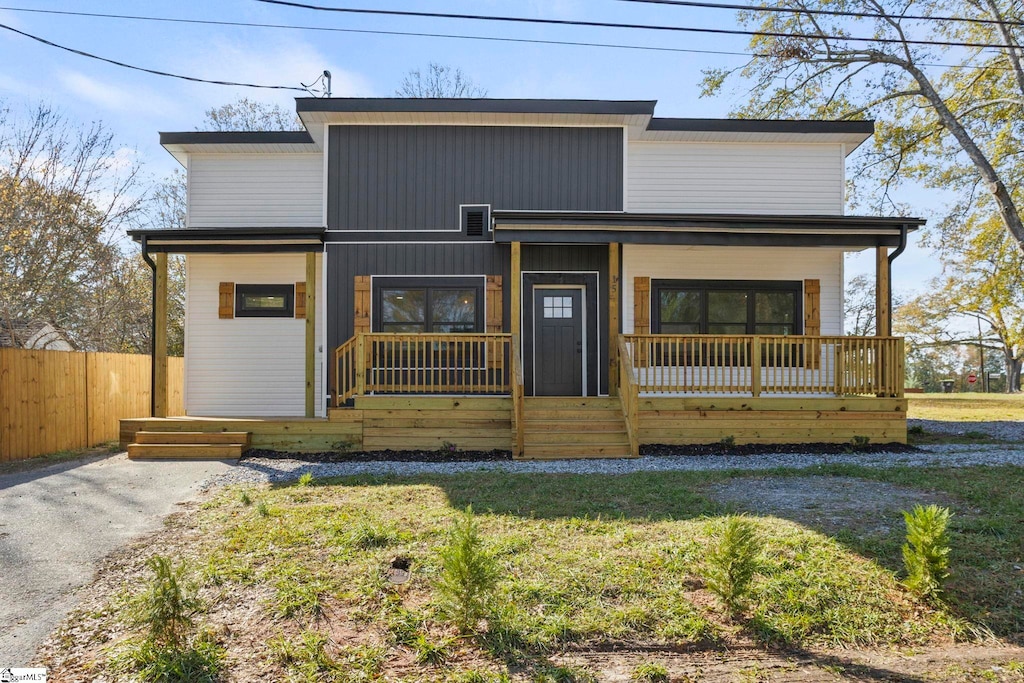 view of front of property with covered porch and a front yard