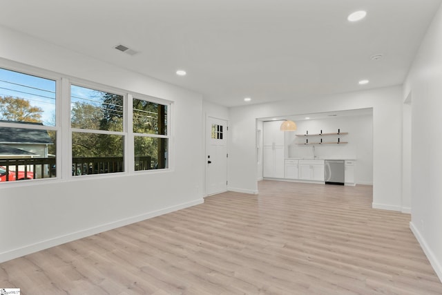 unfurnished living room with light wood-type flooring