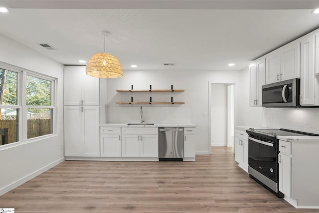 kitchen featuring white cabinets, stainless steel appliances, and sink