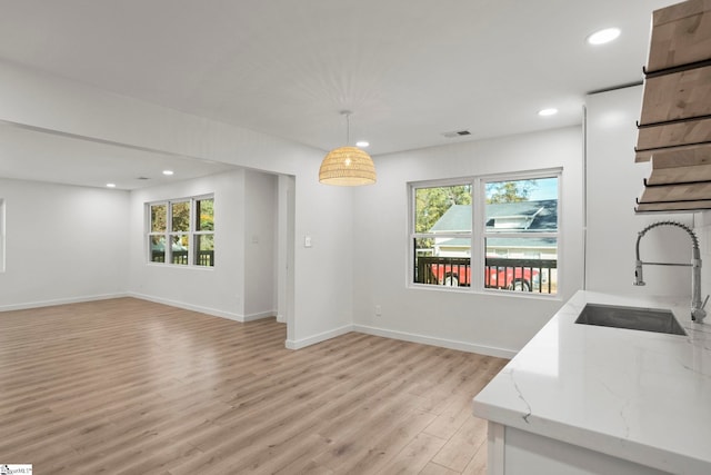 dining area with sink and light hardwood / wood-style flooring