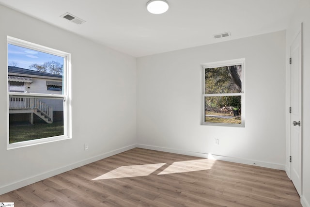 unfurnished room featuring light hardwood / wood-style flooring