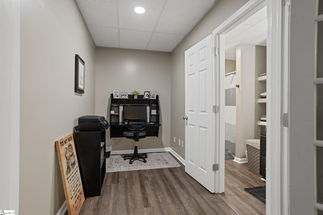 home office with hardwood / wood-style flooring and a drop ceiling