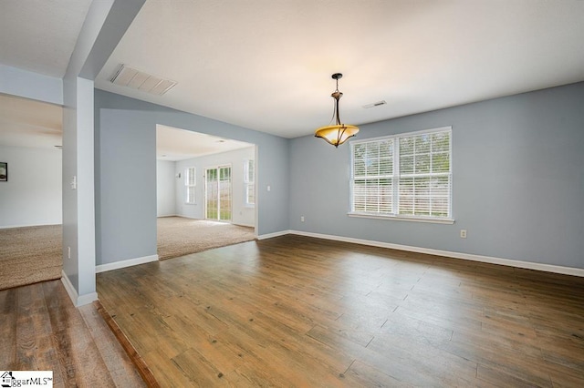 unfurnished room featuring hardwood / wood-style floors and plenty of natural light