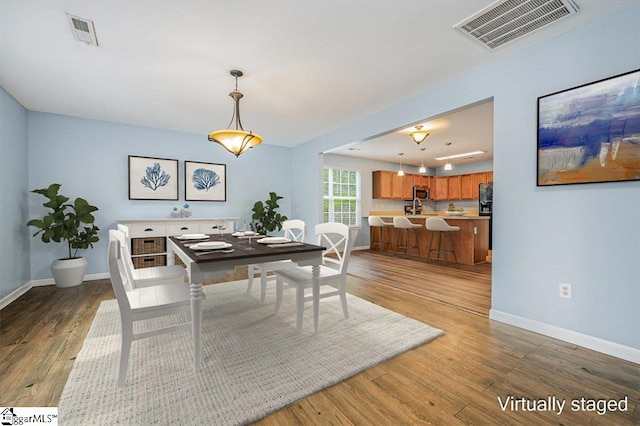 dining area with hardwood / wood-style floors