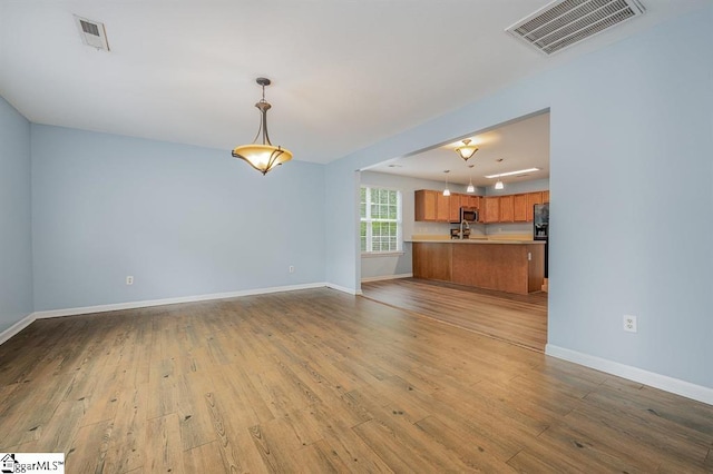 unfurnished living room with light hardwood / wood-style flooring