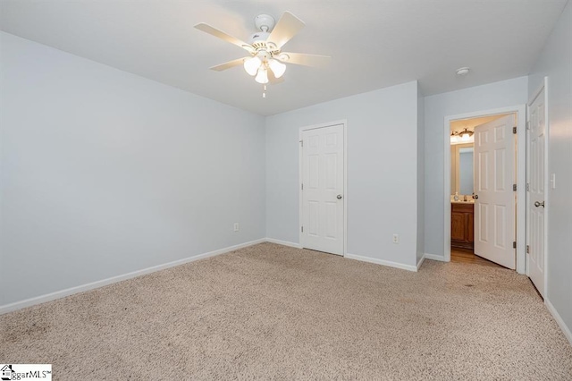 unfurnished bedroom featuring ceiling fan, a closet, and light colored carpet