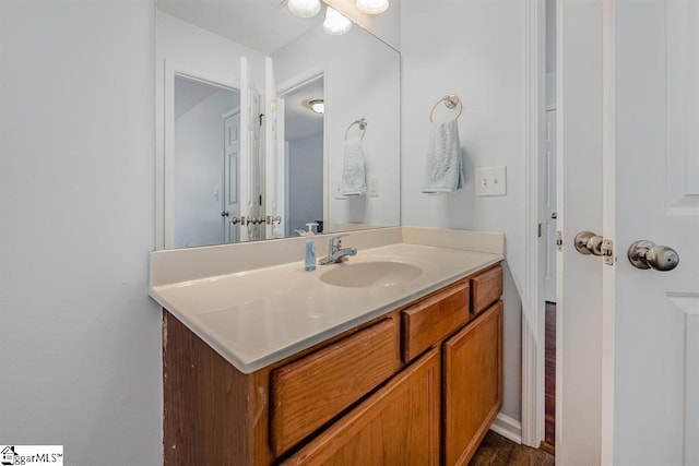 bathroom with vanity and wood-type flooring