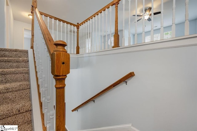 staircase featuring ceiling fan