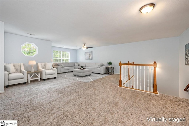 living room with light colored carpet and ceiling fan