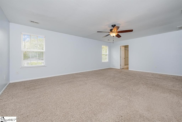 spare room with light carpet and ceiling fan