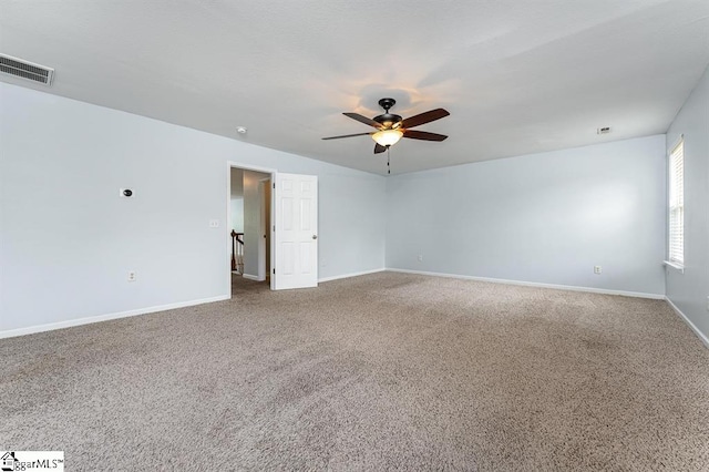 spare room featuring ceiling fan and carpet floors