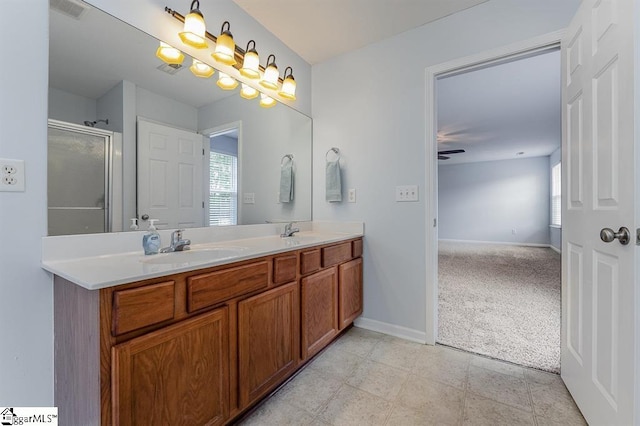 bathroom featuring ceiling fan, a shower with door, vanity, and tile patterned flooring