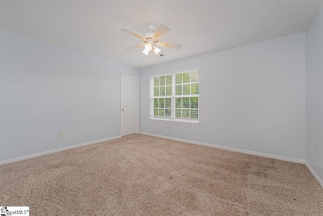 carpeted empty room featuring ceiling fan