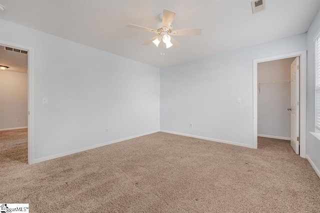 empty room with carpet floors and ceiling fan