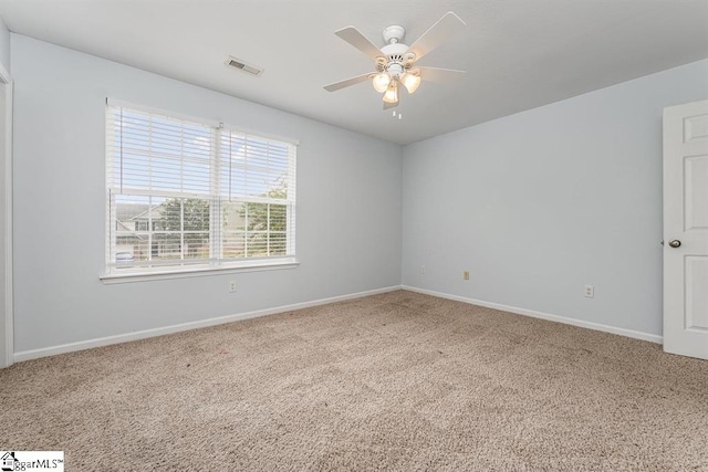 carpeted empty room featuring ceiling fan