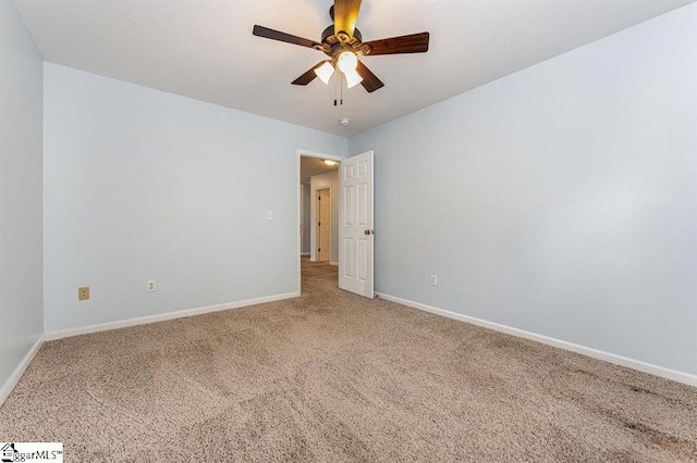 carpeted spare room featuring ceiling fan