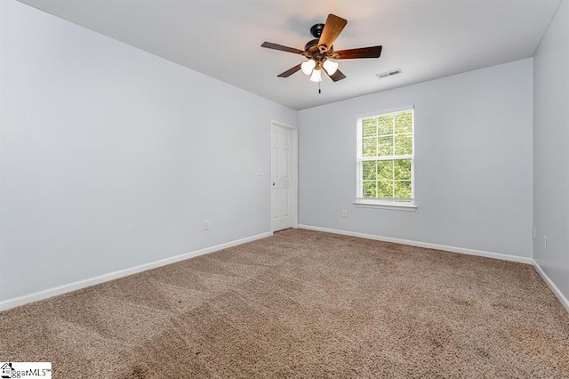 carpeted empty room featuring ceiling fan