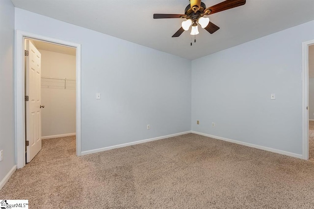 unfurnished room with ceiling fan and light colored carpet