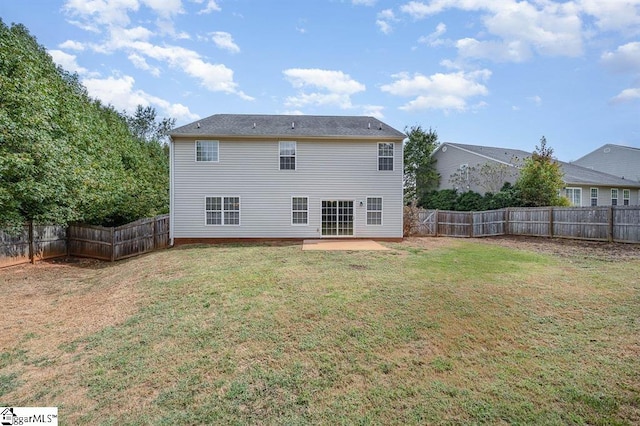 back of property featuring a yard and a patio area