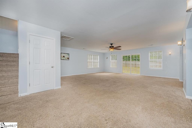 carpeted spare room featuring ceiling fan