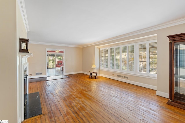 unfurnished living room featuring crown molding and hardwood / wood-style flooring