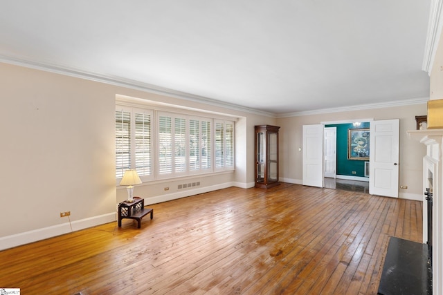 unfurnished living room featuring wood-type flooring and crown molding