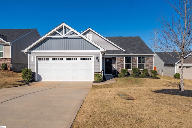 craftsman-style home with a front lawn and a garage