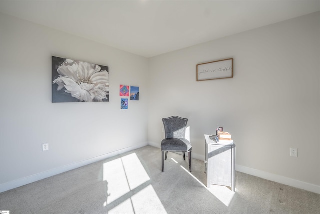 sitting room featuring light colored carpet