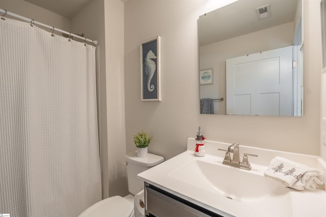 bathroom featuring vanity and toilet