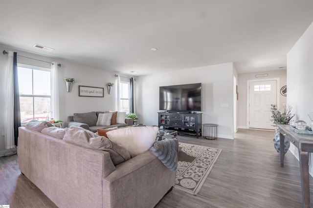 living room with dark hardwood / wood-style floors and plenty of natural light