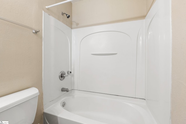 bathroom featuring  shower combination and toilet