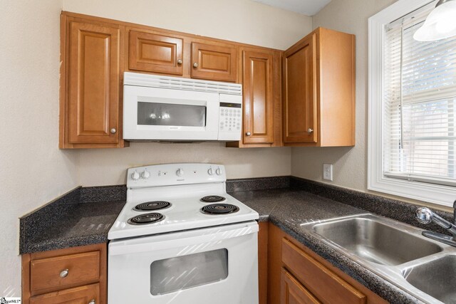 kitchen featuring sink and white appliances