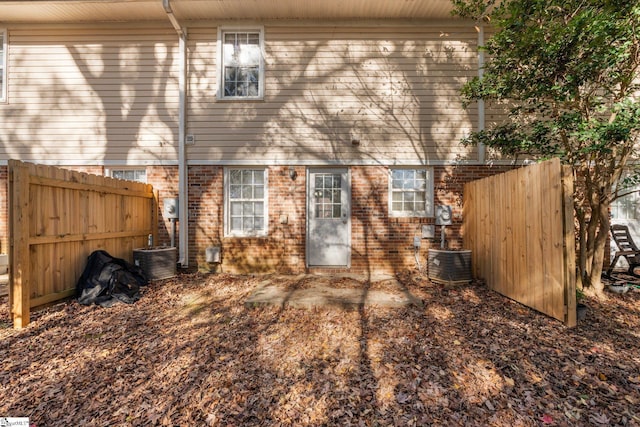 back of house featuring central AC unit