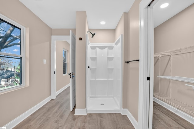 bathroom featuring a shower and wood-type flooring