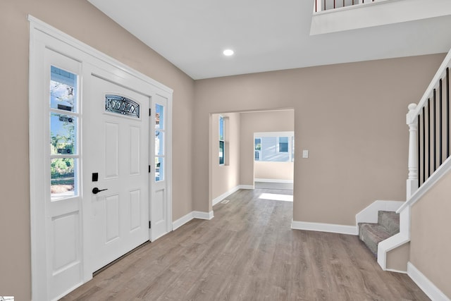 foyer featuring a wealth of natural light and light hardwood / wood-style floors