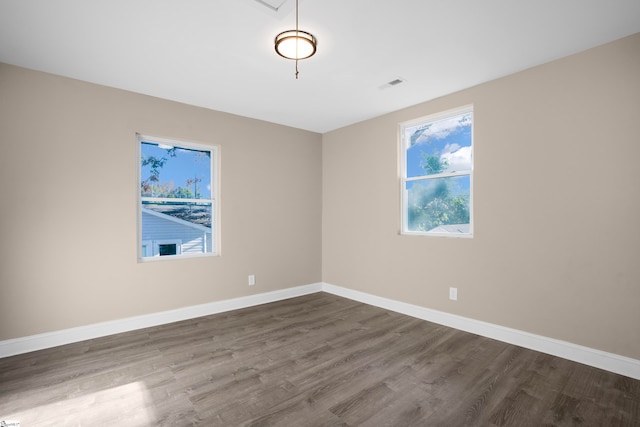 unfurnished room featuring dark hardwood / wood-style floors