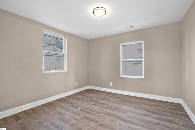 spare room featuring light hardwood / wood-style flooring